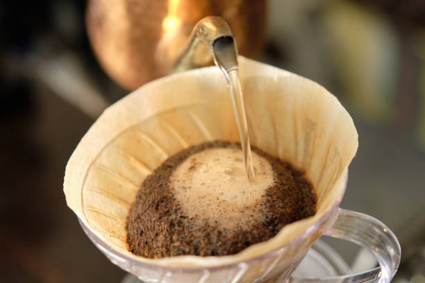 How to make coffee 16: Pour hot water into the coffee How to make coffee 16: Pour hot water into the coffee coffee filter stock pictures, royalty-free photos & images