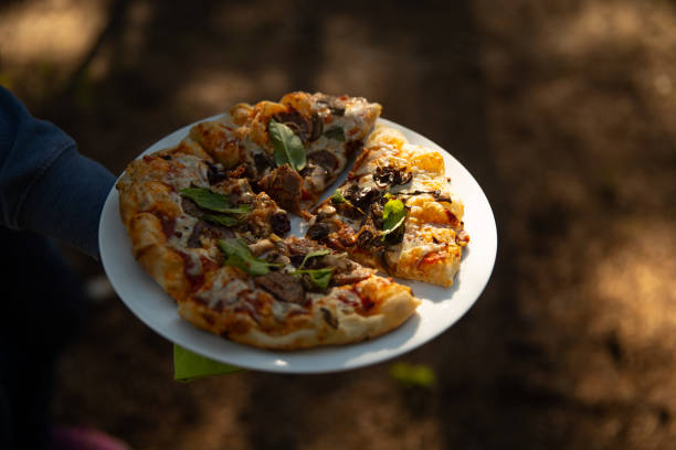 Making wood fired pizza in a outdoor setting.