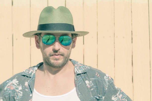 istock Man portrait possing over yellow background at Beach 1242422039