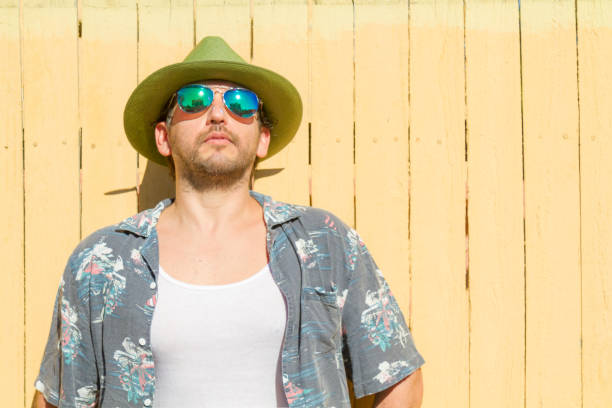 istock Man portrait possing over yellow background at Beach 1242422041