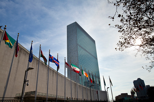 New York, NY, United States - November 12th, 2012: United Nations headquarters building with flags of different countries in front.
