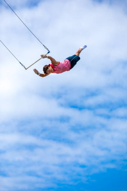 istock Trapeze artist flying in the sky 1242450159