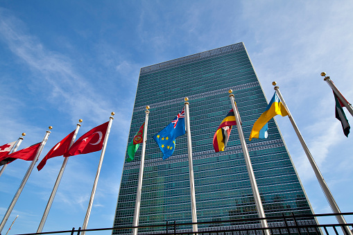 New York, NY, United States - November 12th, 2012: United Nations headquarters building with flags of different countries in front.