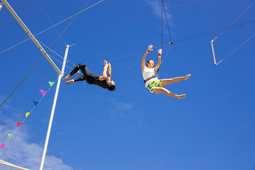 Trapeze artists releasing and jumping to the swing in the sky - part of series (4 of 4)