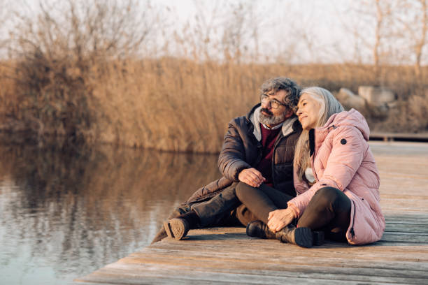istock Senior couple enjoying together on the river dock 1242453873
