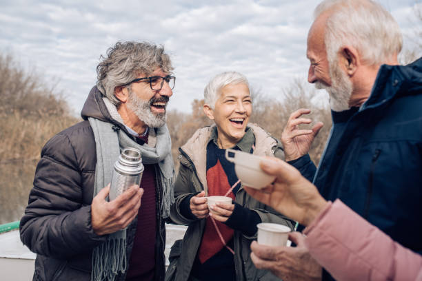 istock Seniors having fun on the river boat, drinking coffee and joking 1242454553