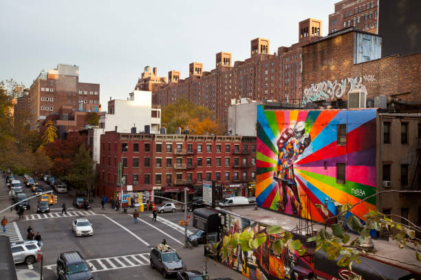 The Kiss - Kobra's Mural New York, NY, United States - November 15th, 2012: Street view with pedestrians walking around and a mural of brazilian artist Kobra. street art mural stock pictures, royalty-free photos & images