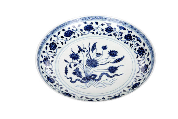 istock Decorative blue and white porcelain plate on white background 1242497648