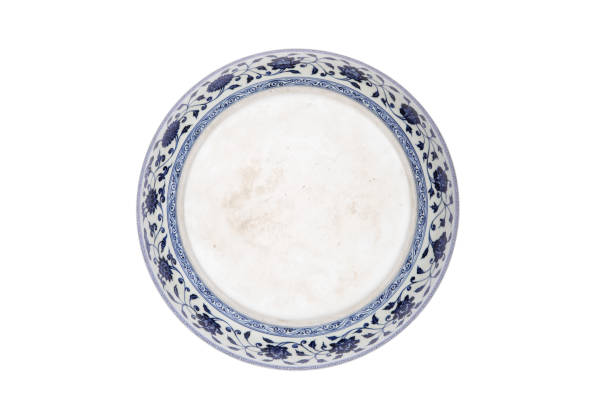 istock Decorative blue and white porcelain plate on white background 1242498872