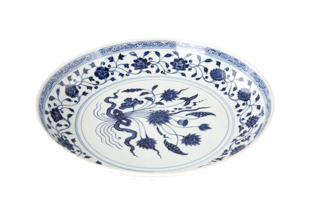 istock Decorative blue and white porcelain plate on white background 1242499382