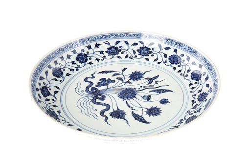 Decorative blue and white porcelain plate on white background