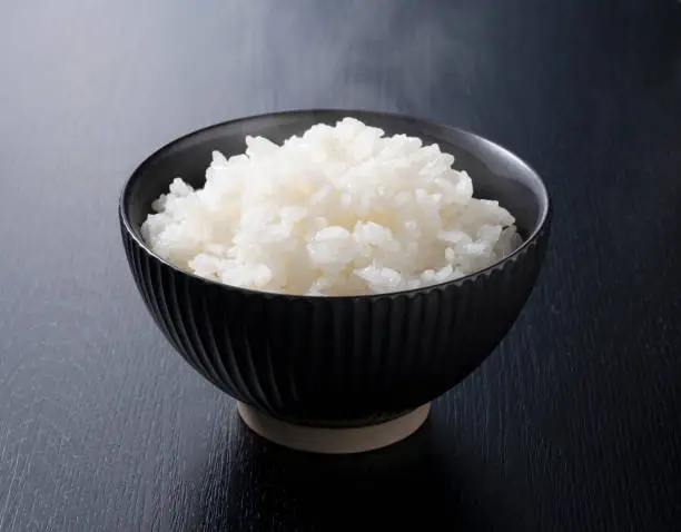 Rice on a black background, taken from an angle