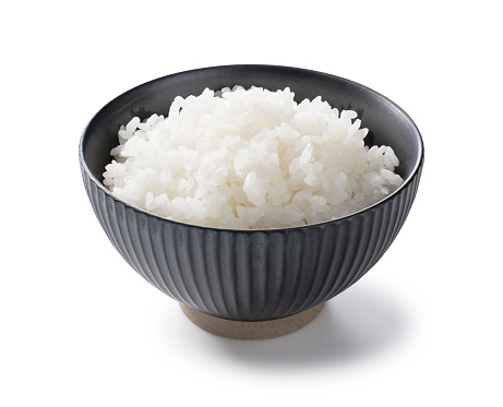 Rice on a white background, photographed from an angle