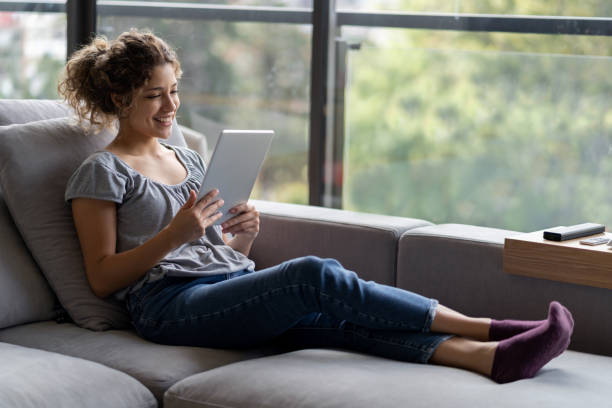 istock Woman in quarantine making a video call using a tablet 1242508930