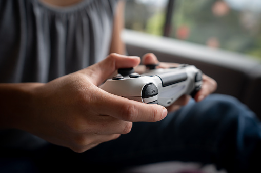 Close-up on a female gamer holding a gaming controller