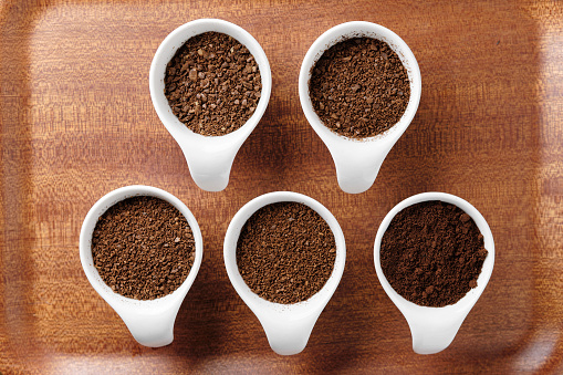 Five levels of ground coffee beans.