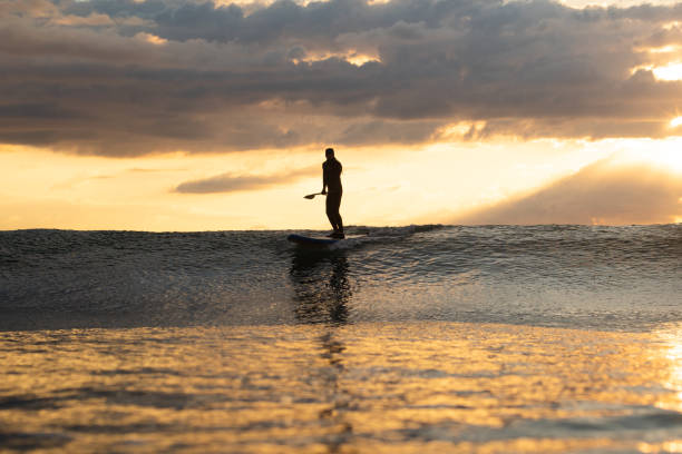 istock Stand Up Paddle Boarding In Japan During a sunrise and sunset after a typhoon 1242554648