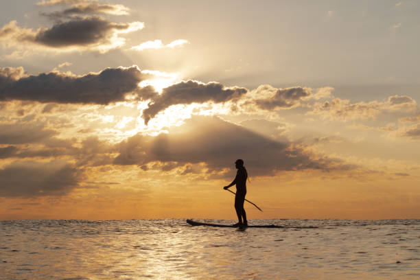 istock Stand Up Paddle Boarding In Japan During a sunrise and sunset after a typhoon 1242554650