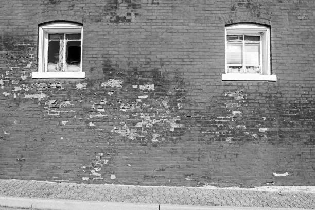 istock Brick exterior building with two windows in black & white 1242560799