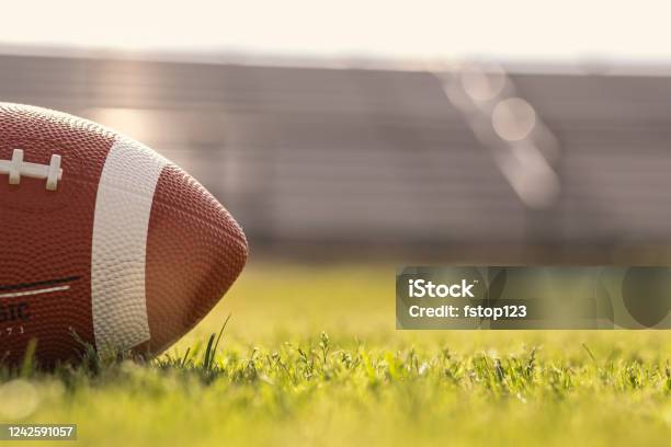 American Football On Stadium Field At School Campus Stock Photo - Download Image Now