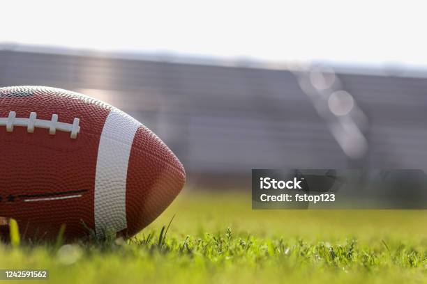 American Football On Stadium Field At School Campus Stock Photo - Download Image Now