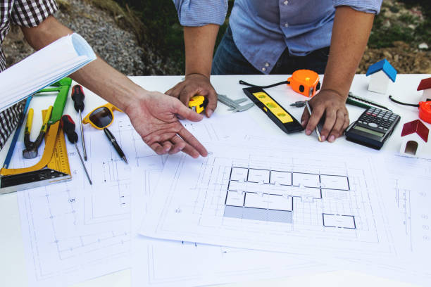 istock Engineer working at the wood table . Modern notebook on table. Pen holding hand. 1242599833