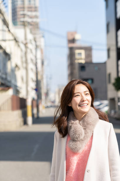 istock asian woman in a coat 1242635455