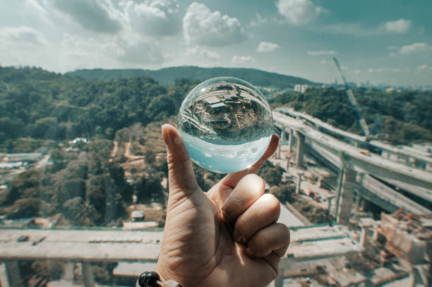 istock human hand holding a crystal ball reflection on highway construction area Pencala Link highway 1242657972