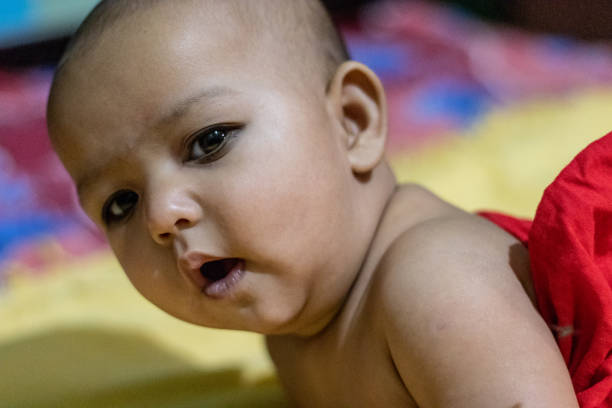 istock baby infant cute innocent facial expression with blurred background 1242688579