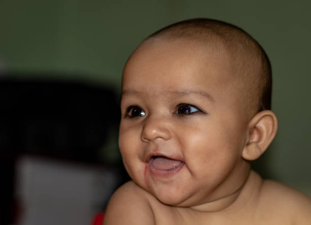 istock baby infant cute innocent smiling facial expression with blurred background 1242690128
