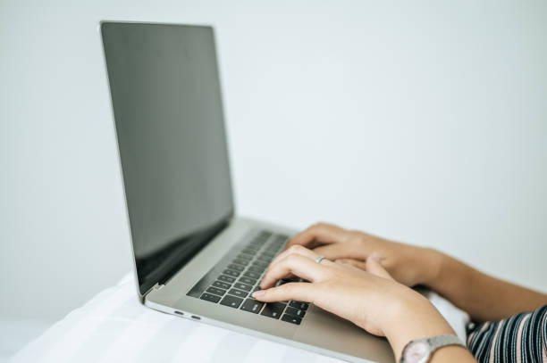 istock A woman's hand that is placed on a laptop. Selective focus. 1242696858