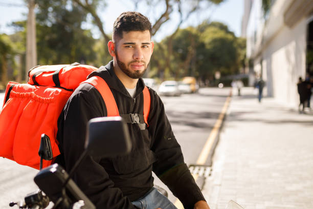 istock Delivery guy portrait on motorcycle - motoboy 1242710106
