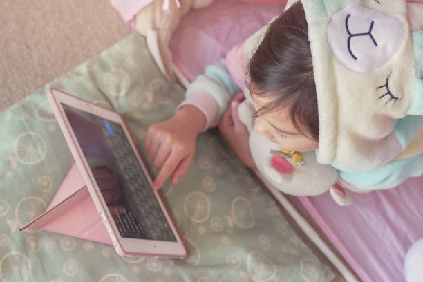 istock Mixed race Asian girl making facetime video calling with tablet at home, using zoom learning online app, social distancing, isolation, homeschooling education, learning remotely concept 1242721897
