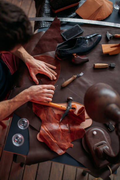 istock messy shoemaker's table , man concentrated on mending shoes 1242740970