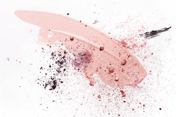 istock Beauty concept with abstract Smudged makeup foundation, broken shadows and sparkles on white background 1242751471