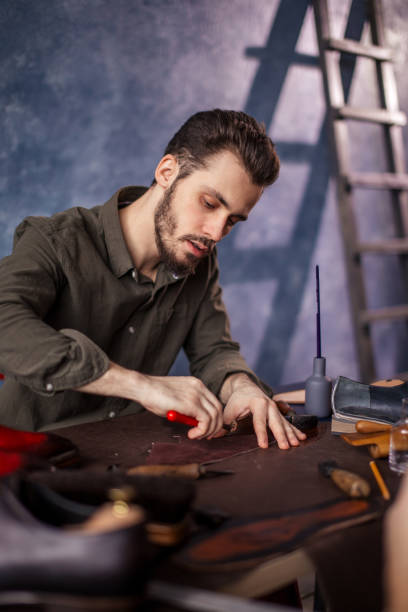 istock young active man cutting black leather with special knife 1242774265