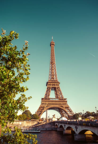 istock The Eiffel Tower in Paris against the backdrop of the Seine River. Retro processing 1242775721