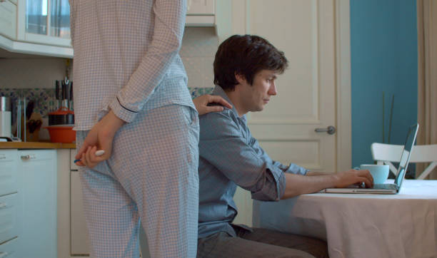 istock A woman holding a pregnancy test behind her back 1242775874
