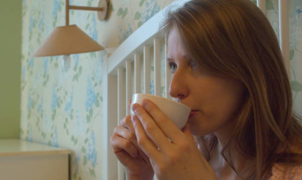 istock Young woman drinking coffee in a bad 1242776914