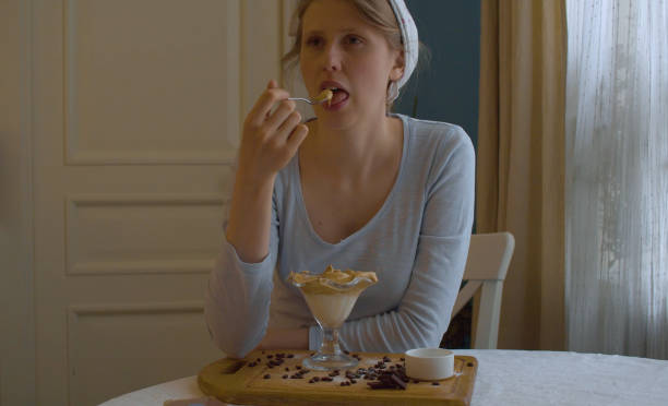 istock Young woman eating Dalgona coffee 1242780084