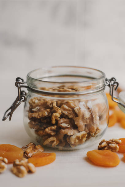 istock Dried apricot and walnut in a glass jar. Container for food storage 1242790149