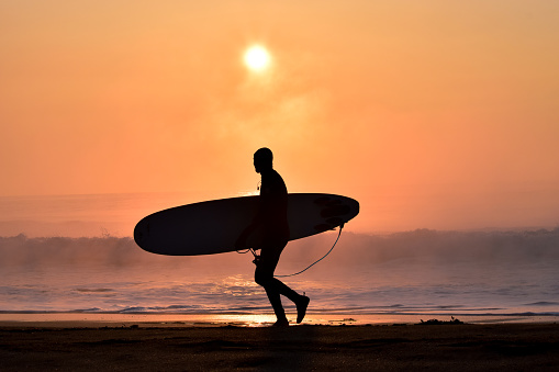Silhouette Surfer on a misty beach in Chiba Japan with a stunning sunrise and waves. Lifestyle, ,surfing, Japan surf, beach, sea & sand, a must see selection