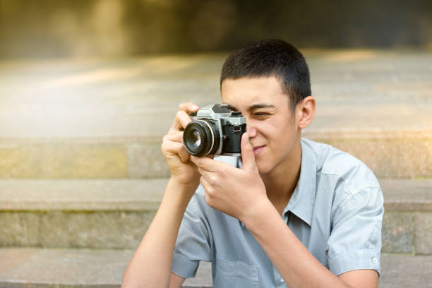 istock Young man taking photographs on his camera 1242816682