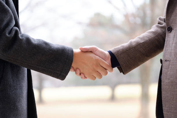 istock A Japanese man shaking hands outdoors. 1242821596