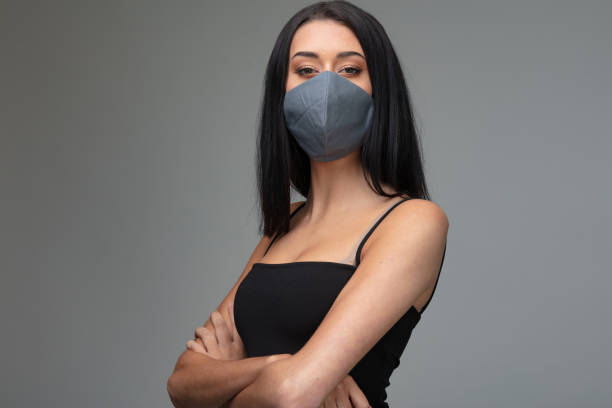 istock Confident attractive woman wearing a face mask 1242832271