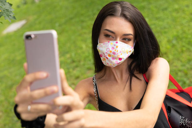 istock Young stylish woman wearing a protective face mask 1242840954
