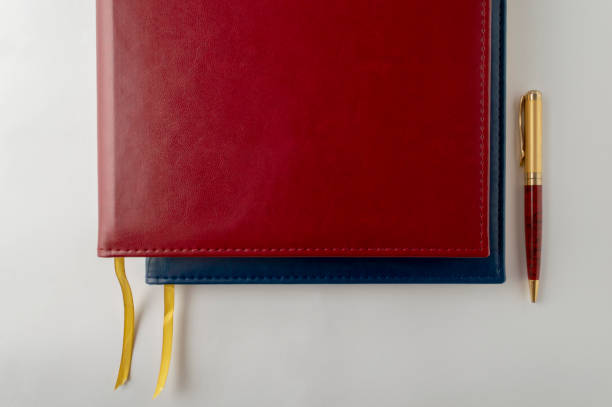 istock Red and Blue Large Notebooks in Leather Binding with a Pen. 1242866702