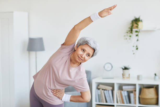 istock Senior woman exercising at home 1242878889