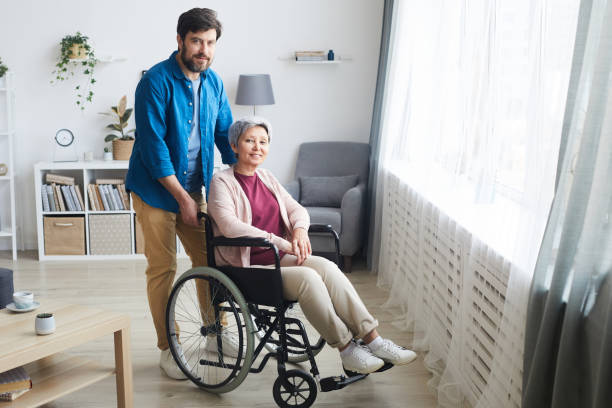 istock Disabled woman with caregiver 1242881673