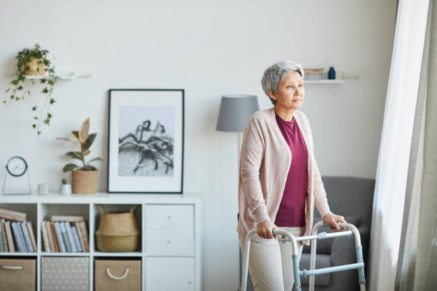 istock Senior woman with walker at home 1242882196